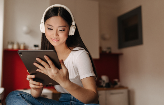 portrait of woman using tablet with headphone